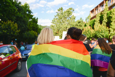 Rear view of people on car against sky