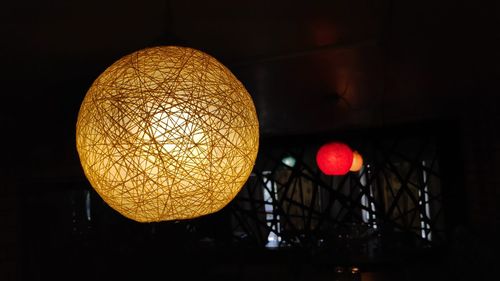 Low angle view of illuminated lanterns hanging on ceiling