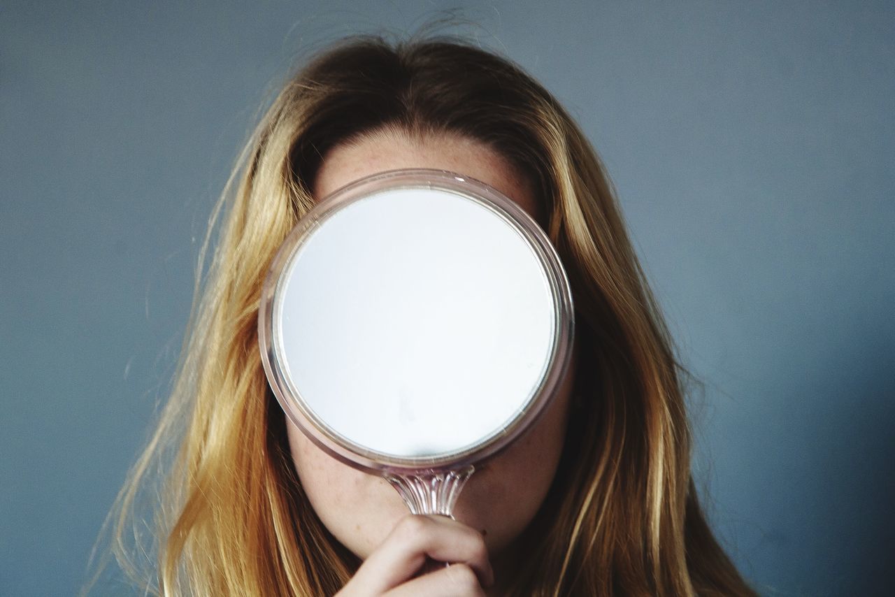 close-up, person, headshot, lifestyles, holding, part of, leisure activity, cropped, studio shot, human face, indoors, copy space, young women, long hair, young adult, focus on foreground