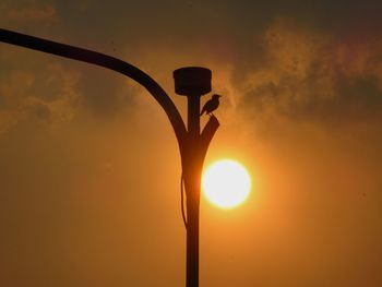 Low angle view of orange sun against sky during sunset