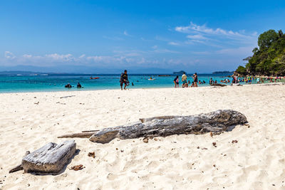 People on beach against sky