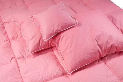 Close-up of pink pillows on bed