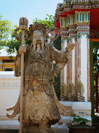 Statue against temple