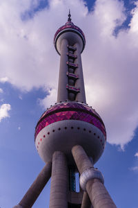 Low angle view of communications tower against sky