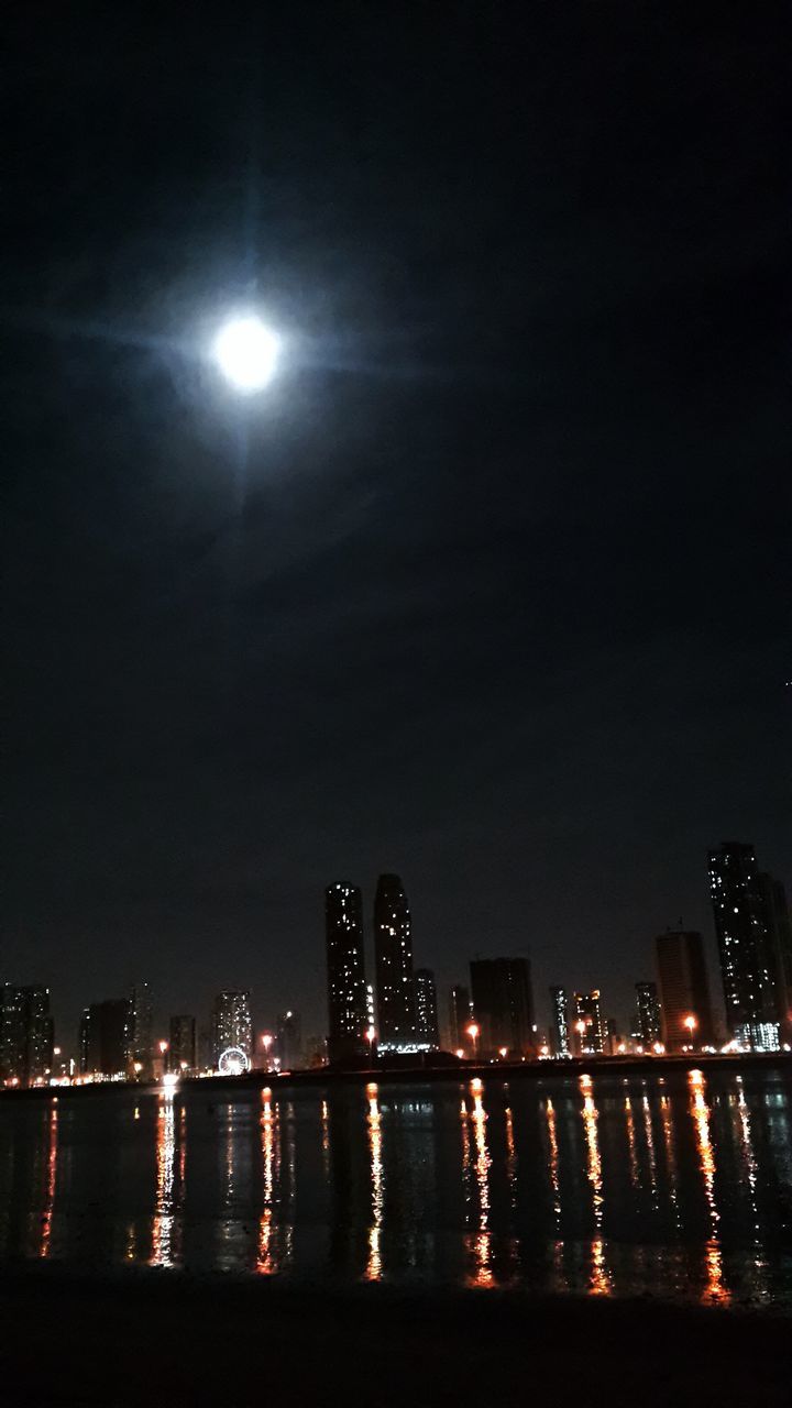 illuminated, night, city, building exterior, architecture, water, built structure, cityscape, river, skyscraper, waterfront, reflection, sky, urban skyline, modern, glowing, tall - high, sea, light - natural phenomenon, lighting equipment