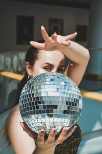 Portrait of woman holding disco ball