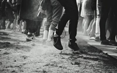 Low section of people walking on street