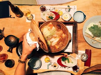 Hand opening pot with soup