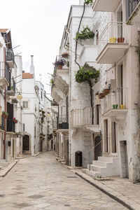 Street amidst buildings in town against sky