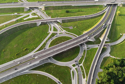 Cars moving on transport road junction in city, aerial view