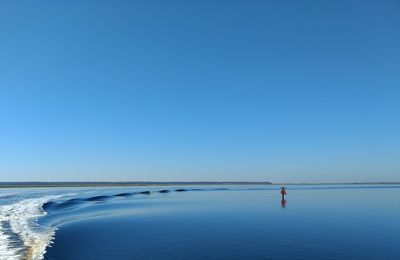 Scenic view of sea against clear blue sky