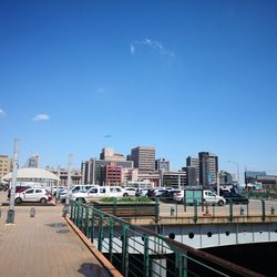 City street and buildings against blue sky