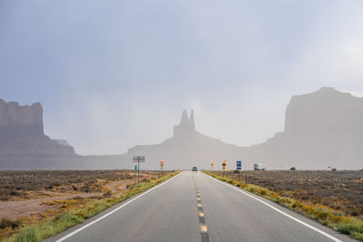 Highway leading towards geological features in monument valley desert