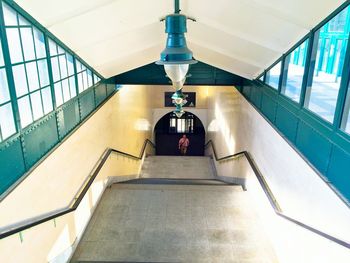 High angle view of man walking on steps at subway station