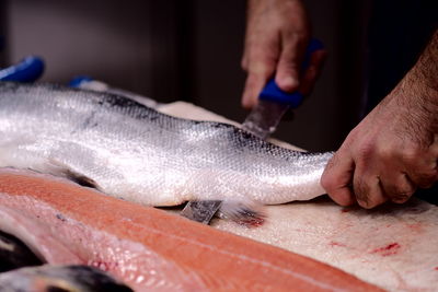 Close-up of man preparing fish