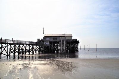 Pier over sea against sky