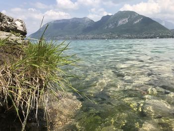 Scenic view of sea and mountains against sky