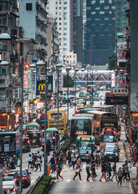 Vehicles on road by buildings in city