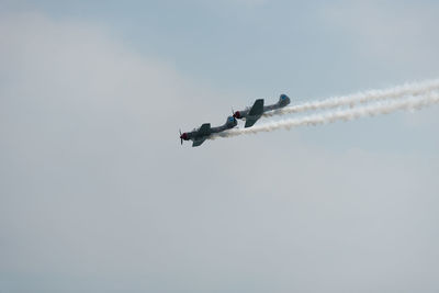 Low angle view of airshow against sky