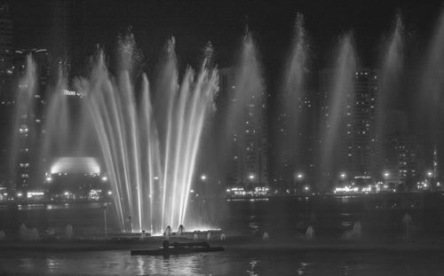 Illuminated fountain at night