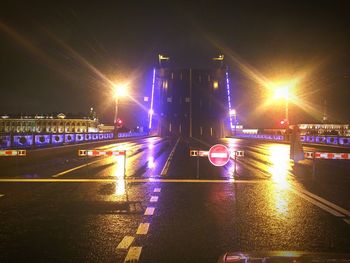 Illuminated bridge against sky at night