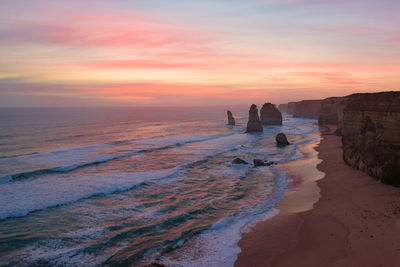 Scenic view of beach against sky during sunset