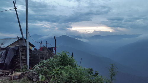 Scenic view of mountains and houses against sky