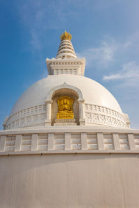 Buddhist stupa isolated with amazing blue sky from unique perspective