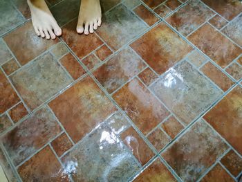 Low section of woman standing by swimming pool