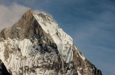 Low angle view of snow covered mountain peak