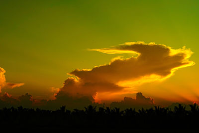 Scenic view of silhouette landscape against orange sky