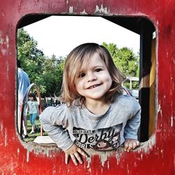 Portrait of smiling girl on outdoor play equipment