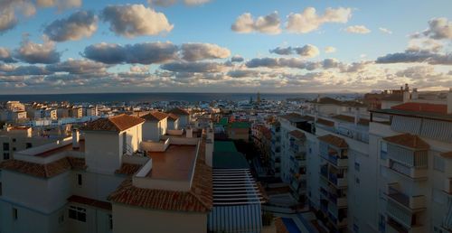 Panoramic shot of town by sea against sky