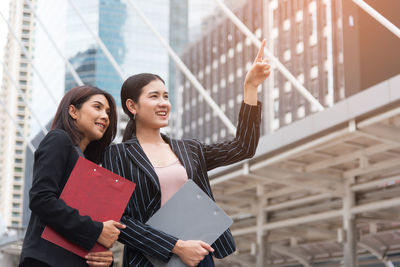 Business people discussing while standing outdoors