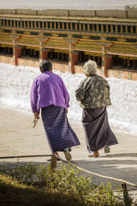 Rear view of couple walking in park