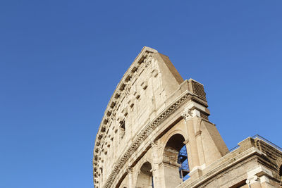 Low angle view of historical building against clear blue sky