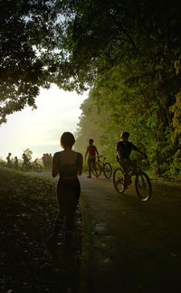 People riding bicycle against sky