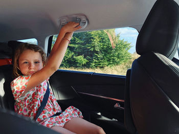 Portrait of girl sitting in car