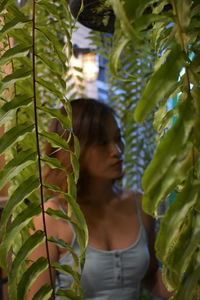 Woman standing amidst plant