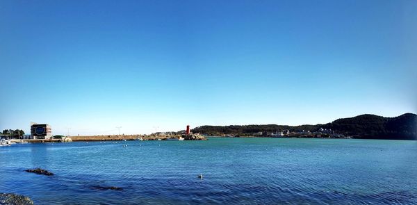 Scenic view of sea against clear blue sky