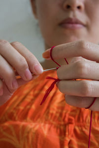 Midsection of woman knitting wool