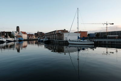 View of marina at harbor against clear sky