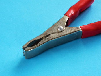 Close-up of plier on blue background