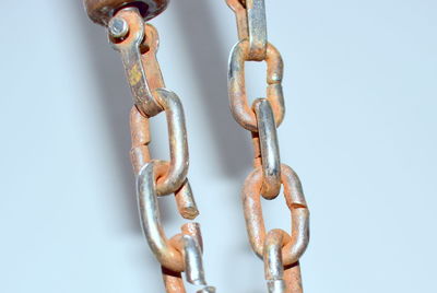 Close-up of rusty chain against white background