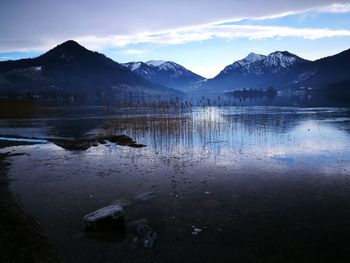 Scenic view of frozen lake against mountain range