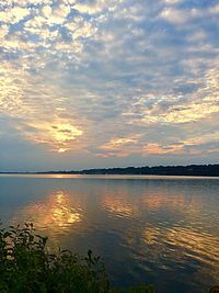 Scenic view of lake against sky during sunset