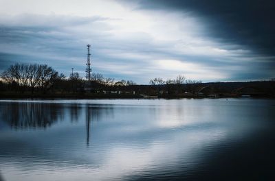 Scenic view of lake against cloudy sky