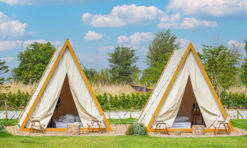 Tent on field against sky