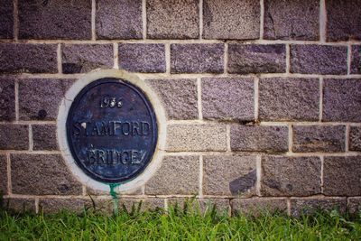 Close-up of text on brick wall