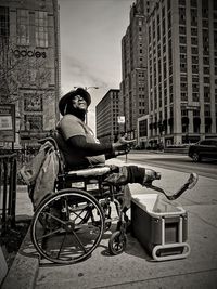 Man with bicycle in front of buildings